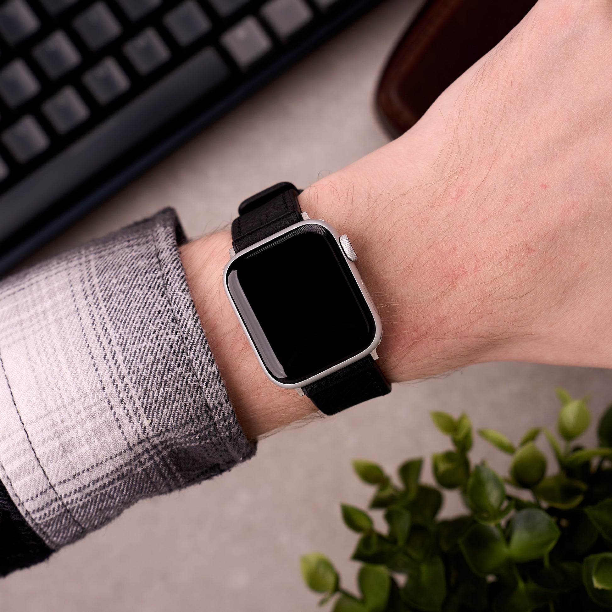 The Tailor leather and FKM rubber Apple Watch band in Black worn on the wrist with an Apple Watch