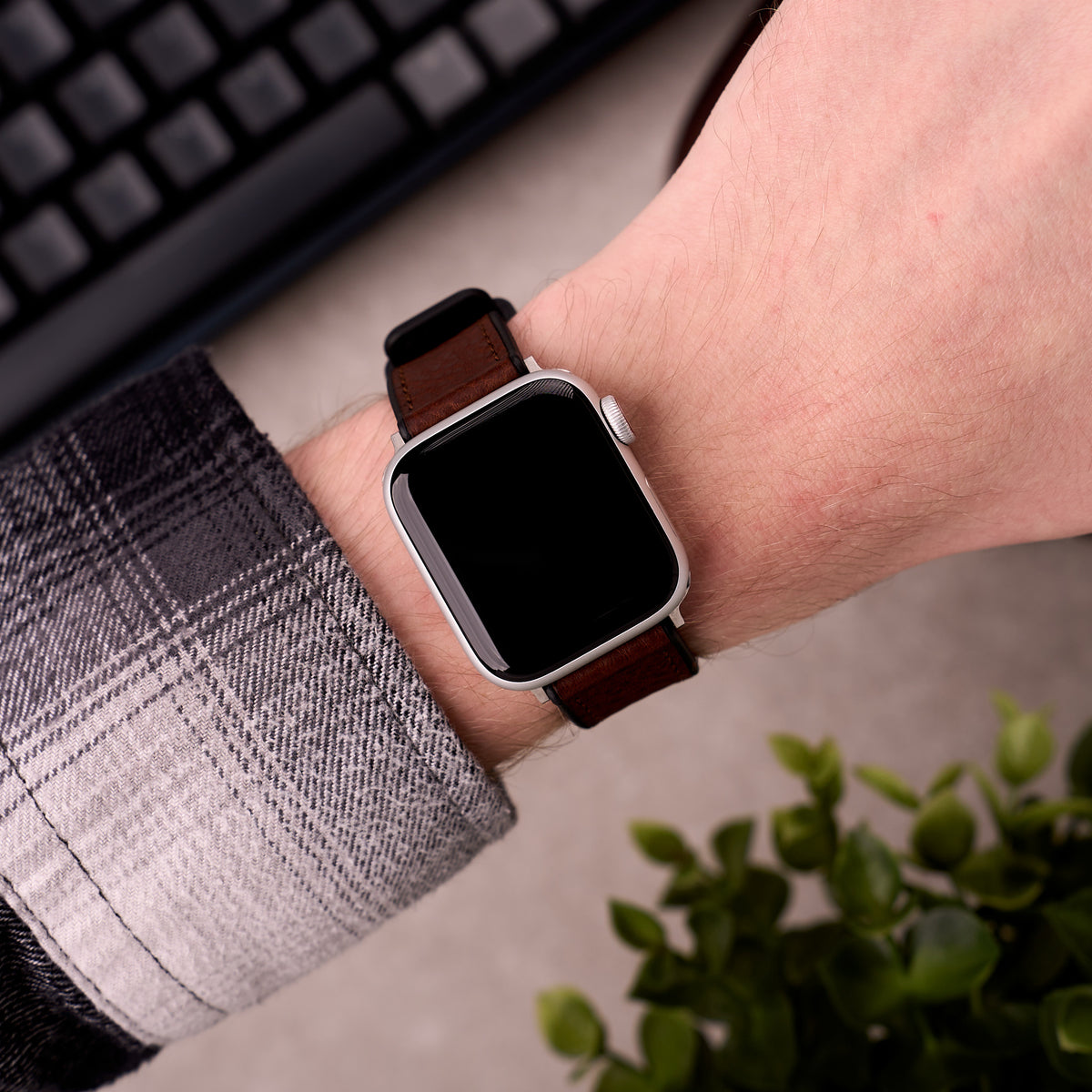 The Tailor leather and FKM rubber Apple Watch band in Brown worn on the wrist with an Apple Watch