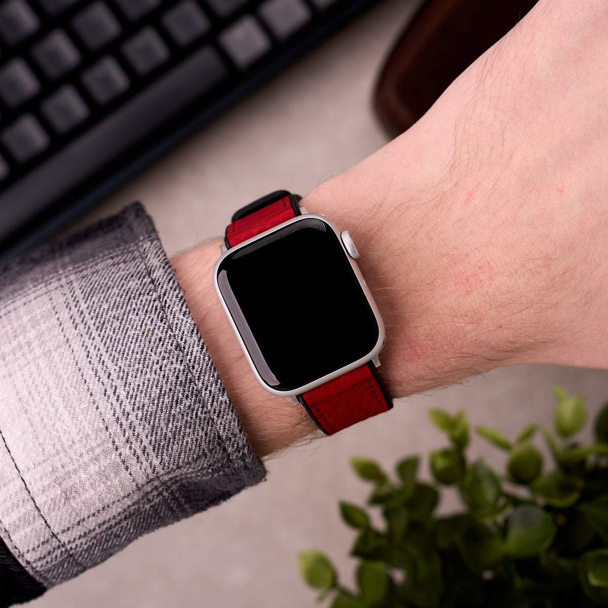 The Tailor leather and FKM rubber Apple Watch band in Red worn on the wrist with an Apple Watch