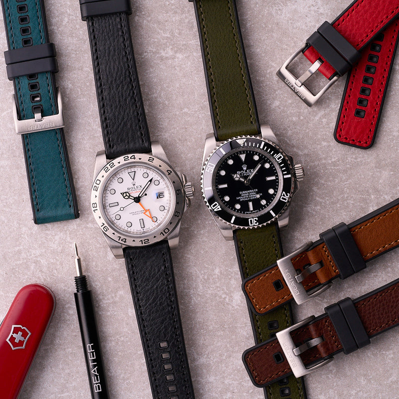 Black Leather Tailor hybrid strap on a watch beside other colours, highlighting the leather top and rubber base construction.