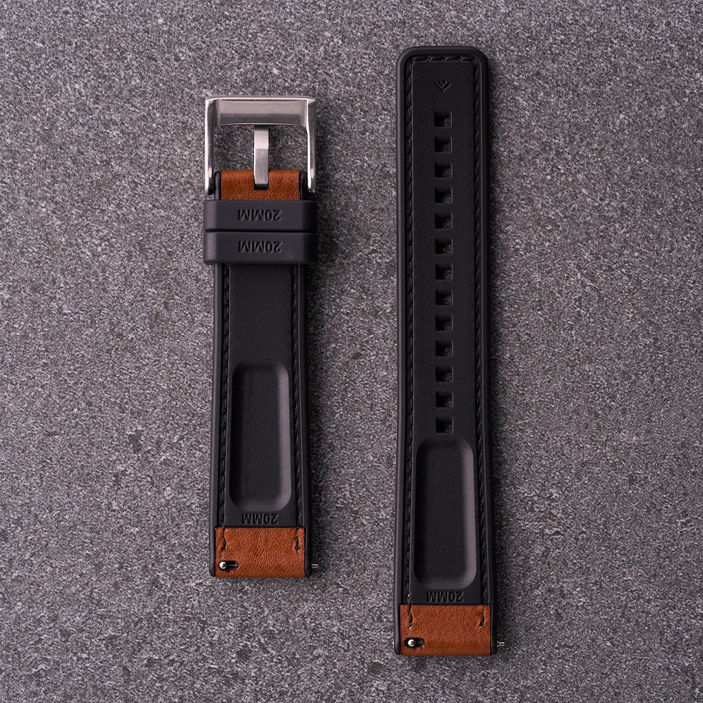 Underside of The Tailor light brown strap showing black FKM rubber lining with quick-release spring bars.